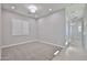Spare bedroom with a window and plush neutral carpeting at 18108 W Thunderhill Pl, Goodyear, AZ 85338