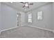 Spacious carpeted bedroom featuring neutral walls and a ceiling fan at 18108 W Thunderhill Pl, Goodyear, AZ 85338