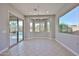 A dining room space featuring a chandelier, windows and a sliding glass door to the back yard at 18108 W Thunderhill Pl, Goodyear, AZ 85338