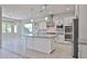 Spacious kitchen with island, stainless appliances, and granite countertops at 18108 W Thunderhill Pl, Goodyear, AZ 85338