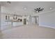 Open-concept kitchen featuring white cabinets, granite countertops, and stainless steel appliances at 18108 W Thunderhill Pl, Goodyear, AZ 85338