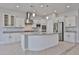 Modern kitchen featuring a kitchen island, stainless steel appliances, and granite countertops at 18108 W Thunderhill Pl, Goodyear, AZ 85338