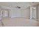 An open-concept living room space with tile floors and a ceiling fan at 18108 W Thunderhill Pl, Goodyear, AZ 85338