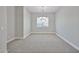 Large room with stylish light fixture and a window at 18108 W Thunderhill Pl, Goodyear, AZ 85338