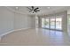Living room features sliding glass doors that lead to the pool in the back yard at 18108 W Thunderhill Pl, Goodyear, AZ 85338