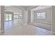 Open living area with tiled flooring, transitions to a carpeted dining room and modern kitchen at 18108 W Thunderhill Pl, Goodyear, AZ 85338