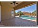 Relaxing covered patio overlooking the pool with beautiful desert landscaping at 18108 W Thunderhill Pl, Goodyear, AZ 85338