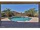 Inviting swimming pool framed by tall palm trees, decorative water features, and privacy fencing at 18108 W Thunderhill Pl, Goodyear, AZ 85338