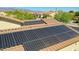 Rooftop solar panels offer energy efficiency to this desert home under a cloudless sky at 18108 W Thunderhill Pl, Goodyear, AZ 85338
