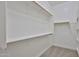 Spacious walk-in closet with carpet and white shelving units providing lots of storage space at 18108 W Thunderhill Pl, Goodyear, AZ 85338