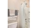 Well-lit bathroom with a shower featuring a white shower curtain and updated fixtures at 1825 E Hampton Ln # 108, Gilbert, AZ 85295