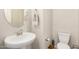 Well-lit powder room with pedestal sink and neutral decor at 1825 E Hampton Ln # 108, Gilbert, AZ 85295