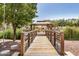 Walking bridge in a community featuring shaded gazebo and lush landscaping at 1825 E Hampton Ln # 108, Gilbert, AZ 85295