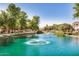 Scenic pond with water features, lush landscaping, and mature trees at 1825 E Hampton Ln # 108, Gilbert, AZ 85295