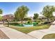 Picturesque view of a community pond surrounded by well-maintained lawns and walkways, enhancing the neighborhood's charm at 1825 E Hampton Ln # 108, Gilbert, AZ 85295