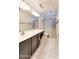 Well-lit bathroom featuring a dual vanity, patterned tile flooring and gray floral shower curtain at 1849 S 96Th St, Mesa, AZ 85209
