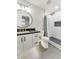 Updated bathroom with a white vanity, black countertop, modern fixtures, and a tiled shower with a rainfall showerhead at 1849 S 96Th St, Mesa, AZ 85209