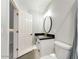 Modern bathroom featuring a white vanity, black countertop, stylish fixtures, and a sleek design at 1849 S 96Th St, Mesa, AZ 85209