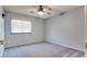 Cozy bedroom featuring neutral carpet, soft blue walls, and a ceiling fan for a calming atmosphere at 1849 S 96Th St, Mesa, AZ 85209