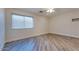 Bright bedroom with hard wood floors and a large window, perfect for comfort and relaxation at 1849 S 96Th St, Mesa, AZ 85209