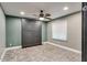 Contemporary bedroom featuring a built-in Murphy bed, stylish patterned floors, a ceiling fan, and window at 1849 S 96Th St, Mesa, AZ 85209