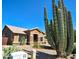Single-story home with desert landscaping and stone accents under a bright blue sky at 1849 S 96Th St, Mesa, AZ 85209