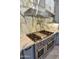Gourmet kitchen with stainless steel range, hood, pot filler, and marble backsplash at 1849 S 96Th St, Mesa, AZ 85209