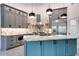 Updated kitchen featuring a marble countertop, stainless steel appliances, gray cabinets and a blue kitchen island at 1849 S 96Th St, Mesa, AZ 85209