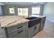 Kitchen island with a black farmhouse sink and marble countertop at 1849 S 96Th St, Mesa, AZ 85209