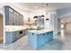 Well-lit kitchen featuring stainless steel appliances, gray cabinets, a blue island, and marble countertops and backsplash at 1849 S 96Th St, Mesa, AZ 85209