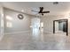 Spacious living room features light gray tile flooring and a ceiling fan at 1849 S 96Th St, Mesa, AZ 85209