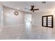 Spacious living room features light gray tile flooring and a ceiling fan at 1849 S 96Th St, Mesa, AZ 85209