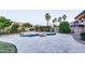 Scenic backyard featuring a swimming pool, patio, and lush landscaping, creating a private oasis for relaxation and fun at 1849 S 96Th St, Mesa, AZ 85209