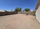 Desert backyard featuring block wall, mature trees, and space for outdoor activities at 1918 S Ocotillo Dr, Apache Junction, AZ 85120