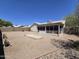 Expansive desert backyard view featuring the screened in patio and mature trees at 1918 S Ocotillo Dr, Apache Junction, AZ 85120