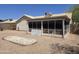 Backyard featuring screened patio, desert landscaping, and space for outdoor activities at 1918 S Ocotillo Dr, Apache Junction, AZ 85120