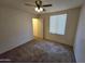 Bedroom with carpeted floors, a ceiling fan, and a view from the window at 1918 S Ocotillo Dr, Apache Junction, AZ 85120