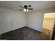 Bedroom featuring carpeted floors, a ceiling fan, a closet, and a door at 1918 S Ocotillo Dr, Apache Junction, AZ 85120