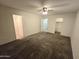 Spacious bedroom featuring neutral-toned walls, ceiling fan, and soft carpeting throughout at 1918 S Ocotillo Dr, Apache Junction, AZ 85120