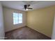 Bedroom featuring carpeted floors, a ceiling fan, and a window for natural light at 1918 S Ocotillo Dr, Apache Junction, AZ 85120