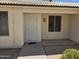 Welcoming front entrance featuring a security screen door and desert landscaping at 1918 S Ocotillo Dr, Apache Junction, AZ 85120