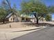 Charming single-story home featuring a well-manicured front yard with mature trees, desert landscaping and a two-car garage at 1918 S Ocotillo Dr, Apache Junction, AZ 85120