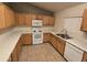 Bright kitchen featuring tile floors, generous counter space, and white appliances for a modern feel at 1918 S Ocotillo Dr, Apache Junction, AZ 85120