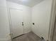 A utilitarian laundry room featuring tile flooring and essential utility connections at 1918 S Ocotillo Dr, Apache Junction, AZ 85120