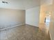 Spacious living room area with tile flooring and access to other rooms in the home at 1918 S Ocotillo Dr, Apache Junction, AZ 85120