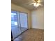 Well-lit living room featuring tile flooring and sliding glass door to screened in patio at 1918 S Ocotillo Dr, Apache Junction, AZ 85120