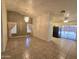 Open-concept living area featuring tile flooring, vaulted ceilings, and access to the patio at 1918 S Ocotillo Dr, Apache Junction, AZ 85120