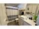 Charming bathroom featuring a modern sink, unique wallpaper, and stylish black and white shower curtain at 2060 N Center St # 275, Mesa, AZ 85201