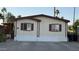 Charming single-story home featuring cream siding, red trim, a concrete driveway, and desert landscaping at 2060 N Center St # 275, Mesa, AZ 85201