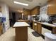 Functional kitchen with oak cabinets, an island with a white countertop, and updated appliances at 2060 N Center St # 275, Mesa, AZ 85201
